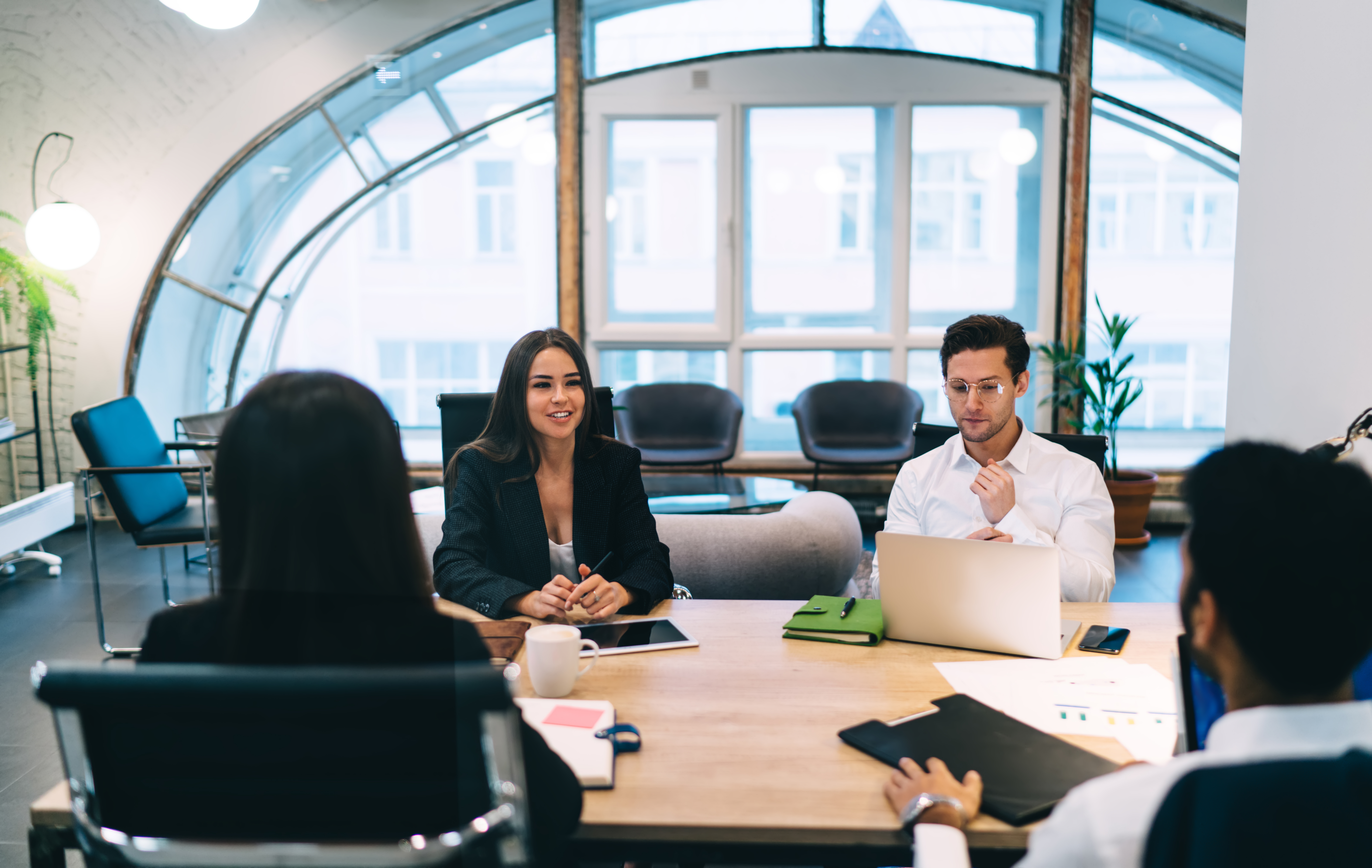 Business colleagues discussing project in workspace